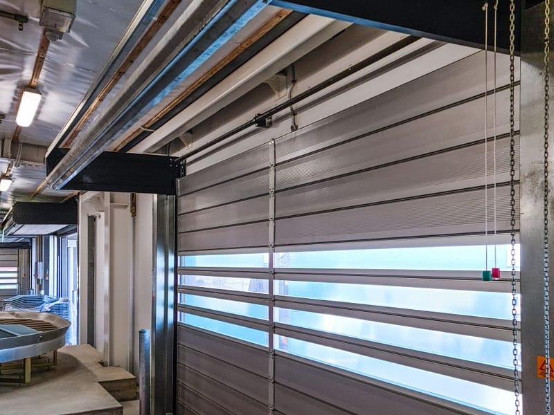 Ulti Spiral Door installed in an airport baggage handling area.